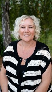 Smiling woman with curly hair outdoors